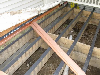  High-quality Deck Moisture Barriers installed by Friendly Earth to protect outdoor decks from water damage and rot.