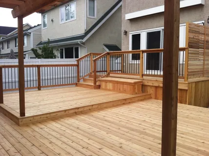 Wooden backyard deck designed by a professional deck company Calgary residents hire for outdoor renovations.